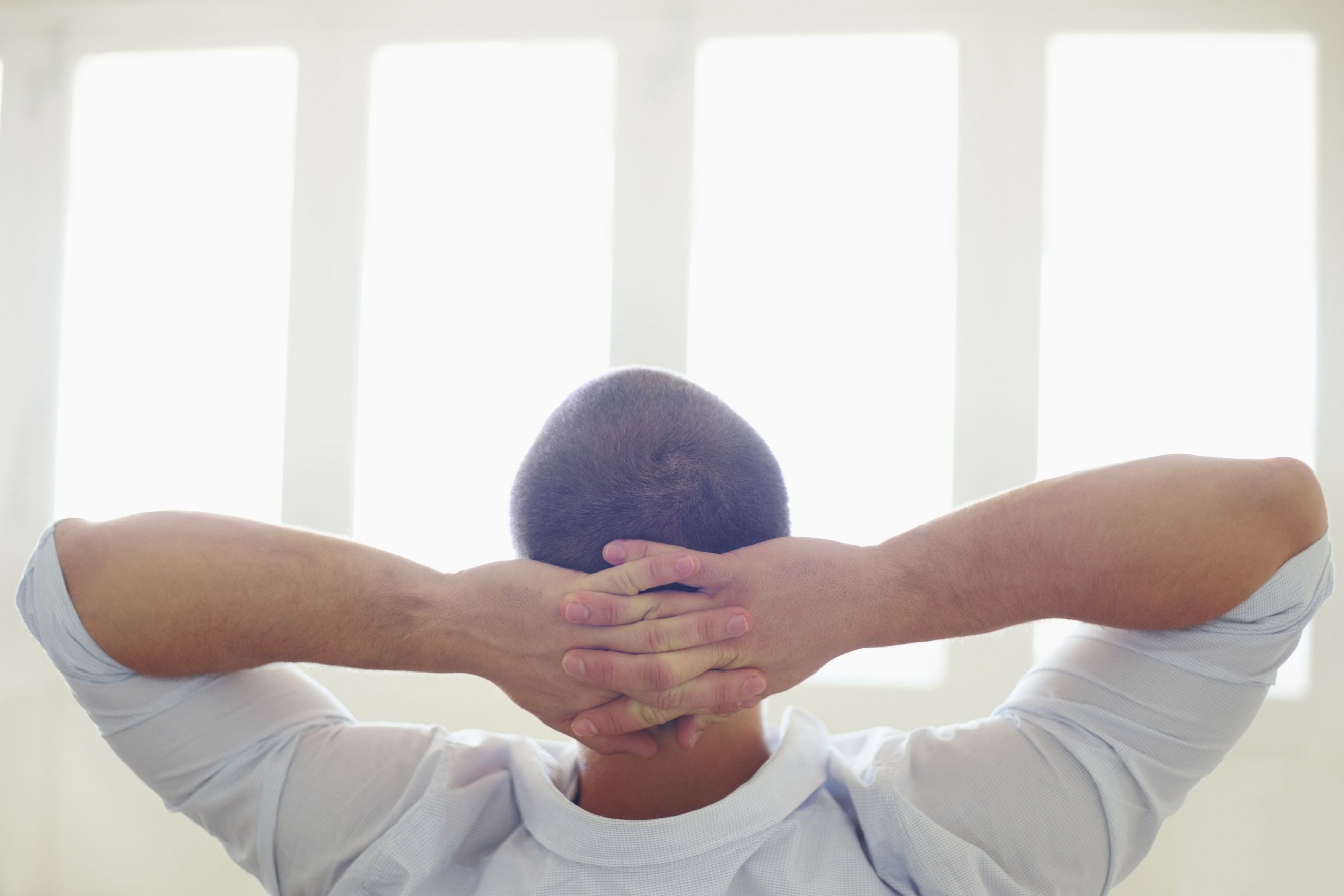 Man relaxing with his hands behind his head