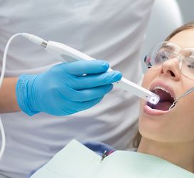 A dentist examines a patient